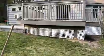 Aging wooden deck with lattice skirting before demolition and rebuild