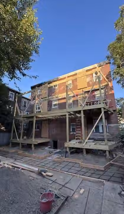 Multi-family building with old rear porches during reconstruction