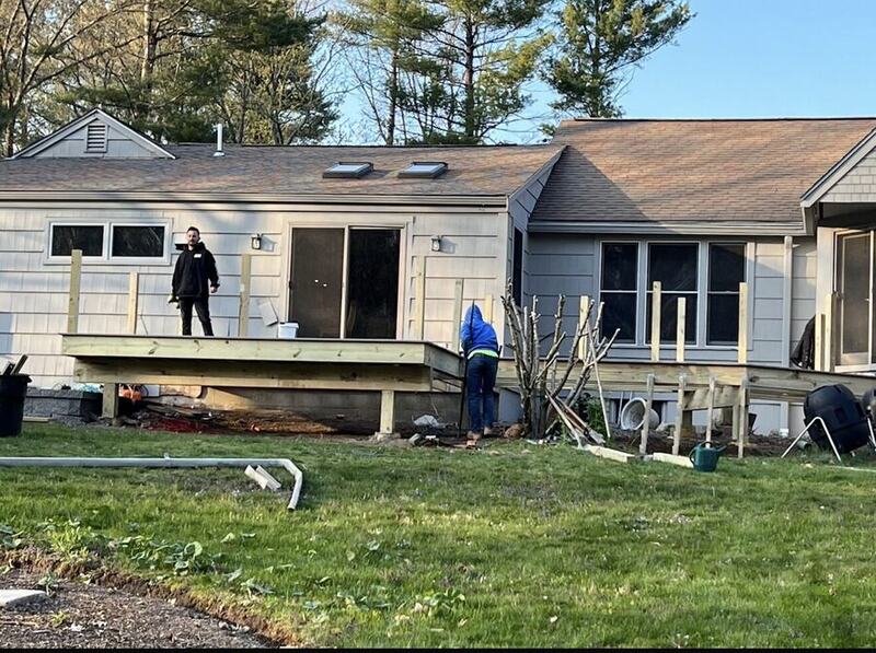 Completed pressure-treated wood deck structure with stairs