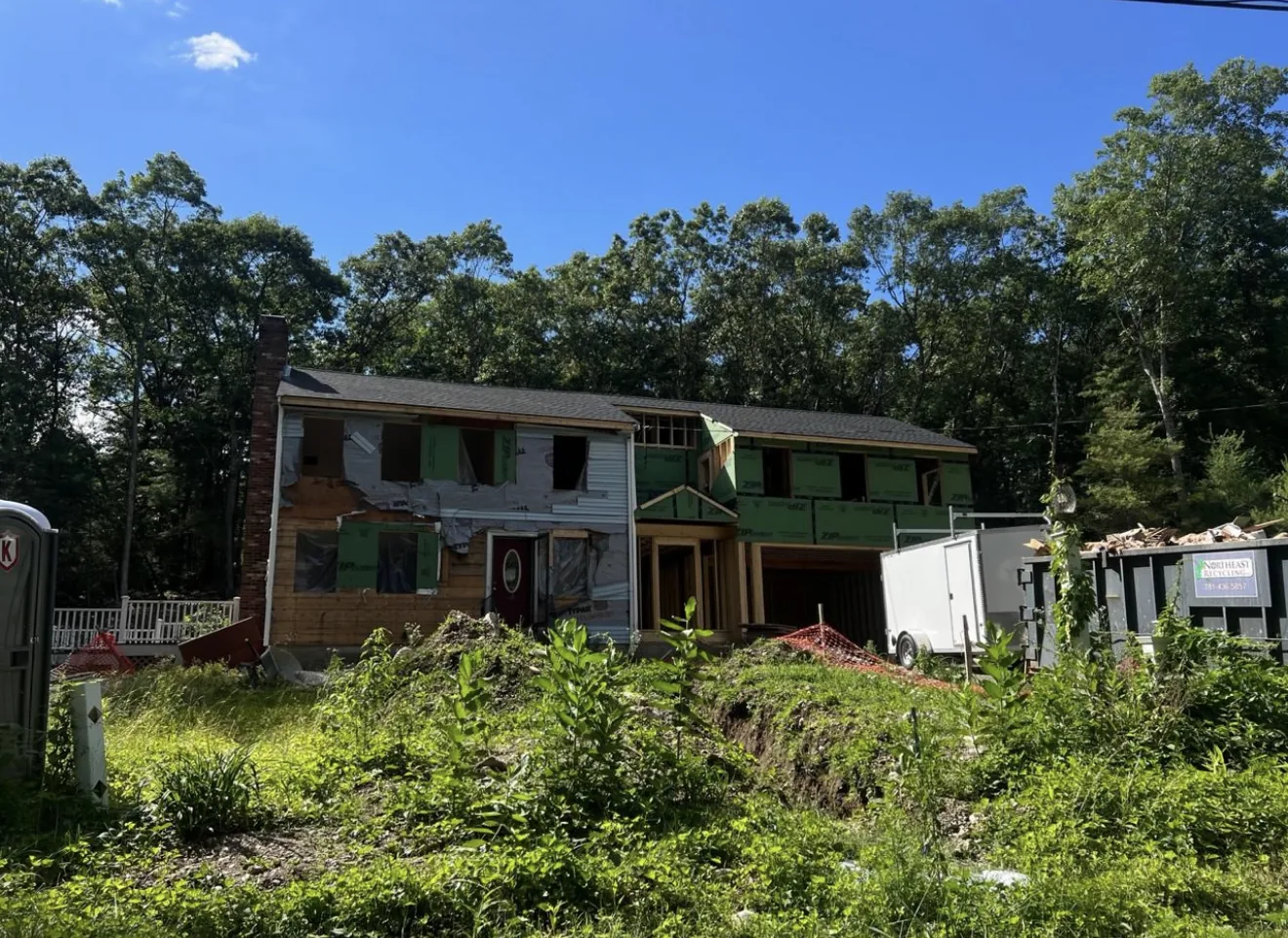 Rear home addition site preparation and foundation work in Massachusetts
